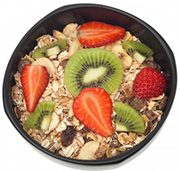 Muesli And Fruits In Bowl Isolated